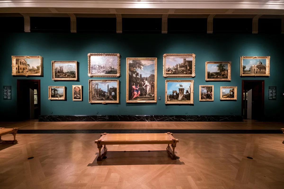 Gallery with illuminated artwork displayed on walls